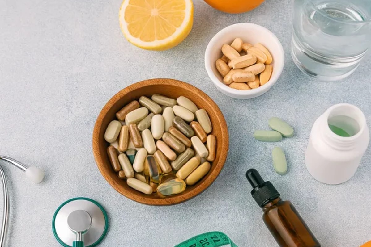 Stethoscope, notebook and dietary supplements on a grey background, the booming dietary supplement industry